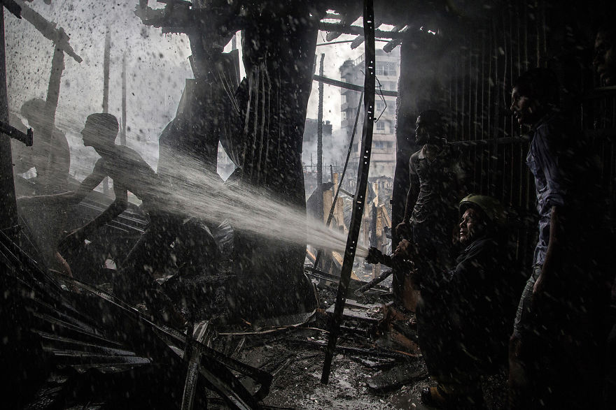 Moradores e bombeiros trabalham em equipe para combater um incêndio causado por um incidente de energia em Bangladesh